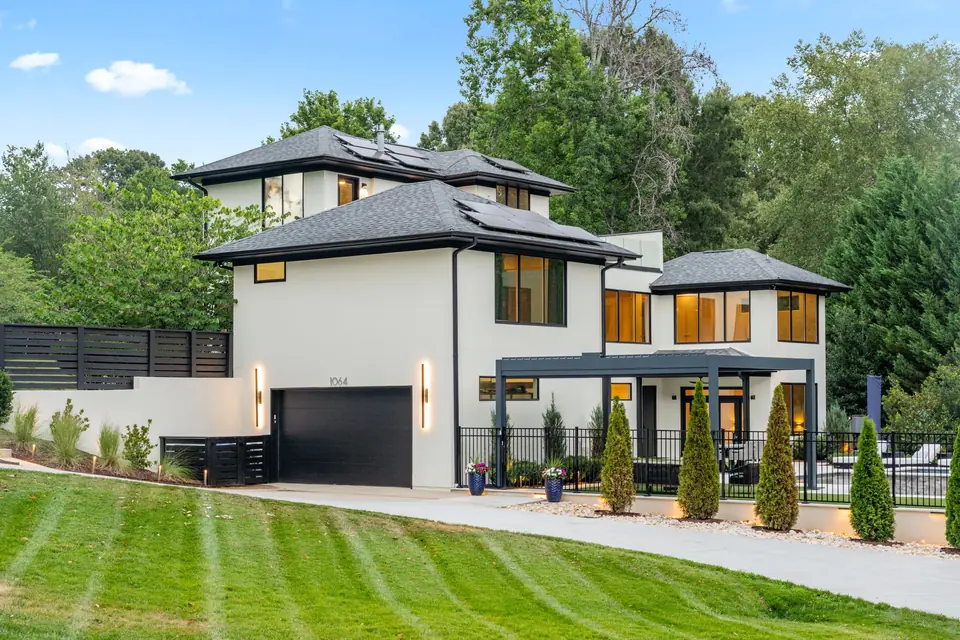 Modern facade, gated drive and landscaped front lawn