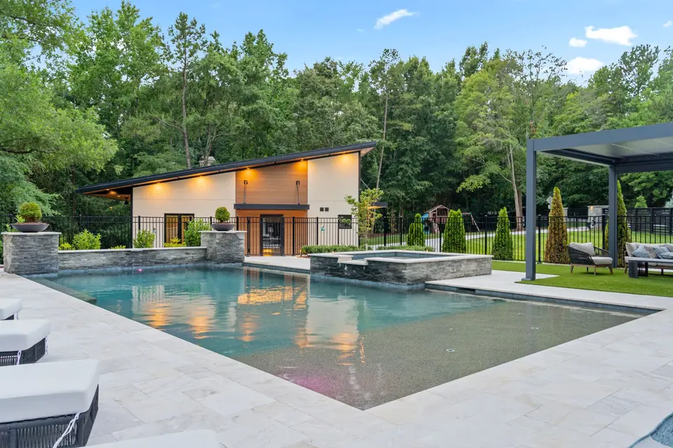 Pool looking toward the accessory building and louvered pergola